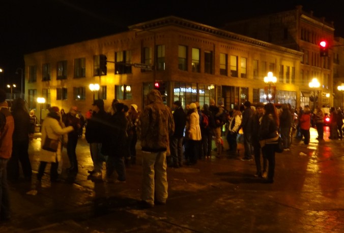Huddled masses watch the Christmas City of the North Parade.